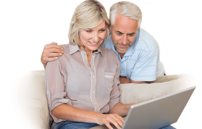 A couple looking at a website together on their couch