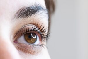 Close up of a woman's eye with long, full eyelashes after Latisse treatment.