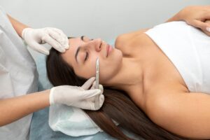 Relaxed woman getting a dermaplaning treatment in a spa-like setting.