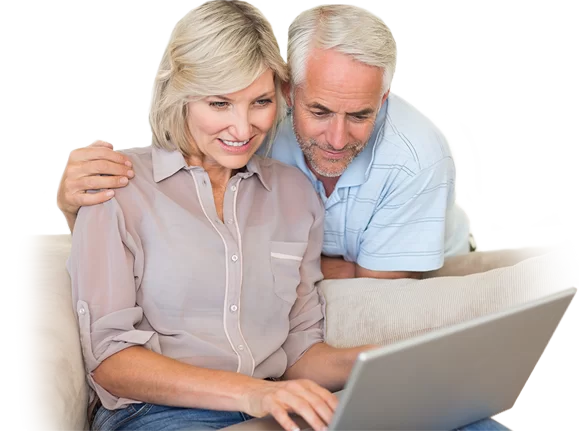 A couple looking at a website together on their couch